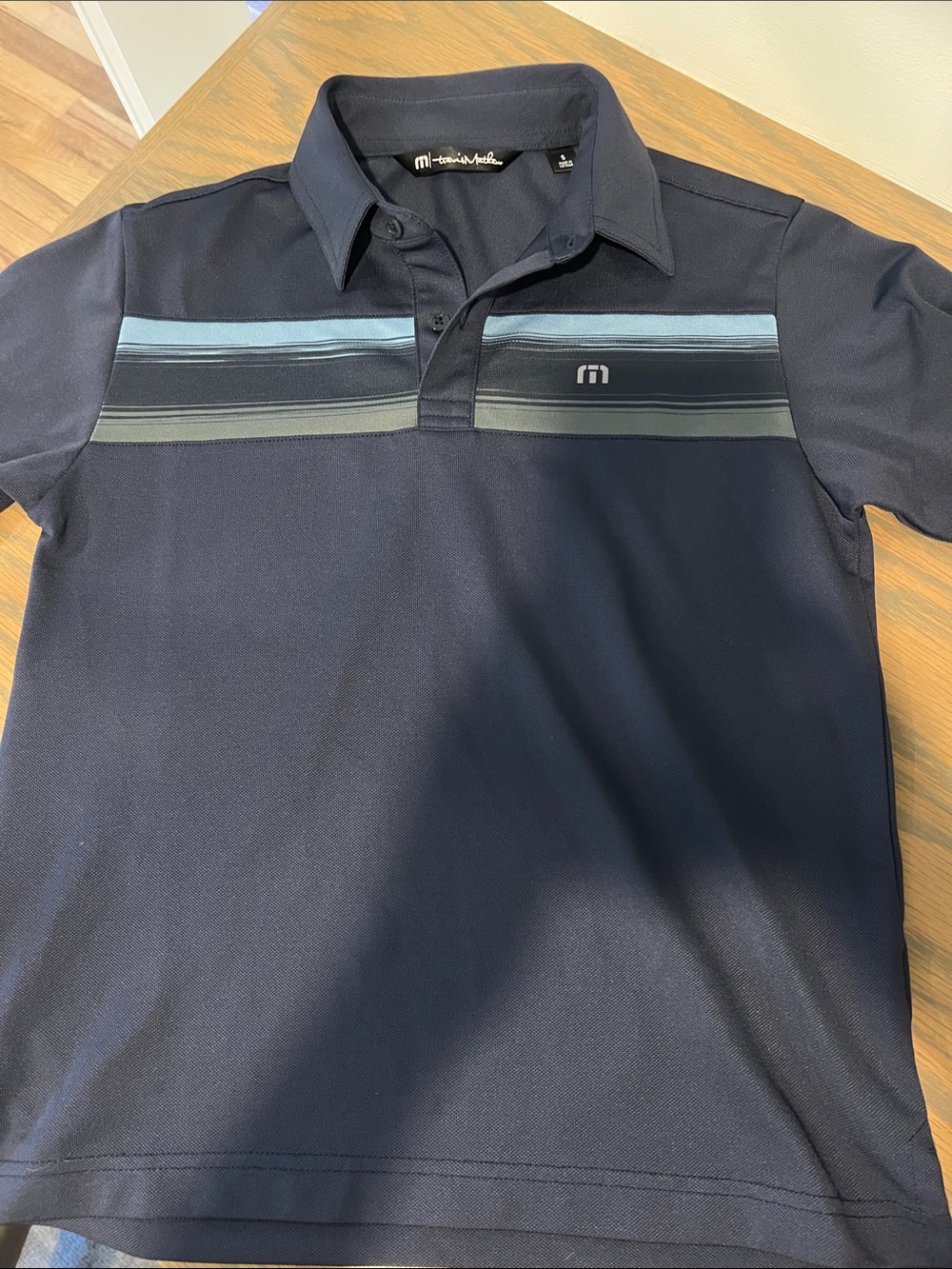 Travis Mathew Navy Polo with Light Blue and Gray Chest Stripes